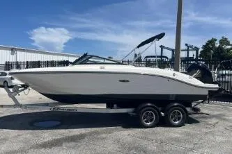 Slide: The Image of 2022 Sea Ray SPX 210 Outboard boat on trailer, parked outdoors under blue sky. - 3