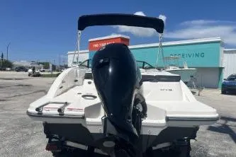 Slide: The Image of 2022 Sea Ray SPX 210 Outboard boat with black motor, parked outdoors. - 6