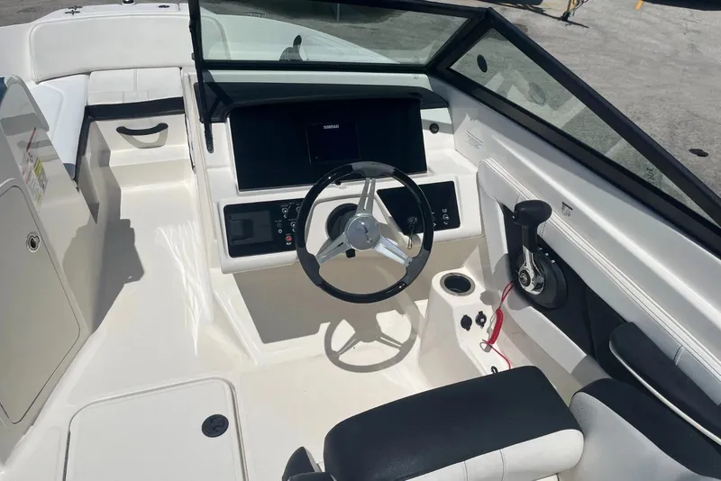 Slide: The Image of 2022 Sea Ray SPX 210 Outboard boat cockpit with steering wheel and control panel. - 7