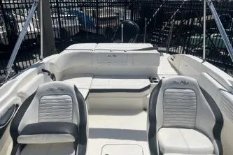 Slide: The Image of 2022 Sea Ray SPX 210 Outboard boat interior with white seating and sleek design. - 8