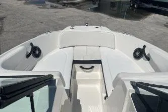 Slide: The Image of 2022 Sea Ray SPX 210 Outboard boat interior with white seating and speakers. - 9
