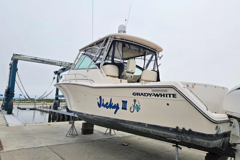 Slide: The Image of 2007 Grady-White Express 360 boat on lift at marina dock. - 2