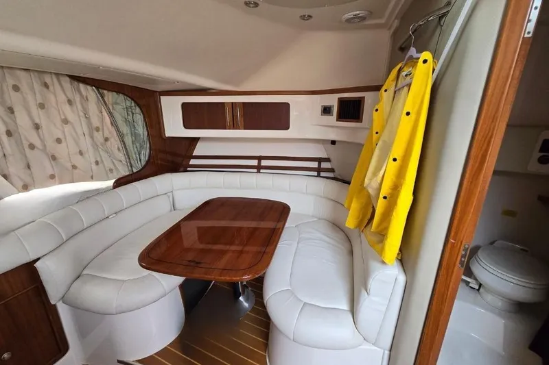 Slide: The Image of Interior of 2007 Grady-White Express 360 boat with white seating and wooden table. - 5