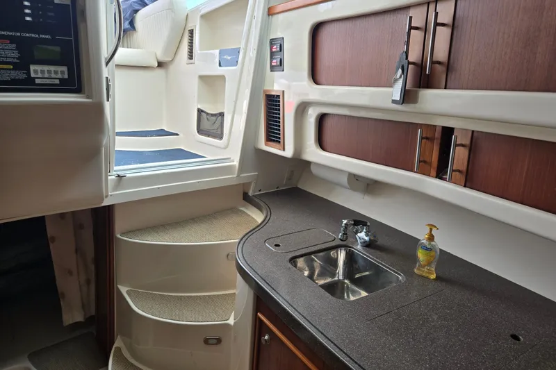 Slide: The Image of 2007 Grady-White Express 360 interior with kitchenette, sink, and stairs. - 6