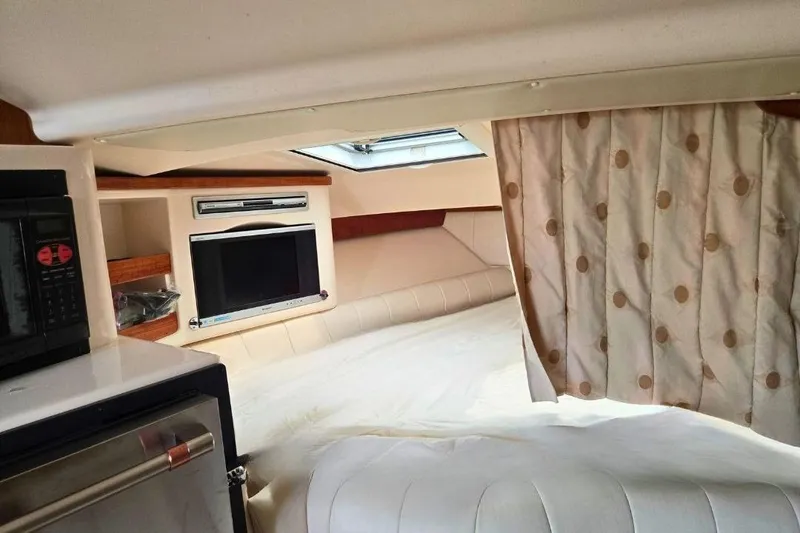 Slide: The Image of 2007 Grady-White Express 360 cabin interior with bed, TV, and microwave. - 7