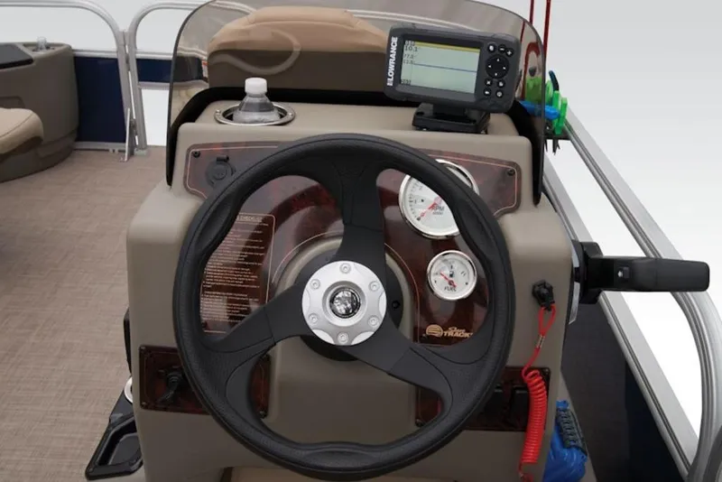 Slide: The Image of 2025 Sun Tracker BASS BUGGY® 18 DLX dashboard with steering wheel and gauges. - 14