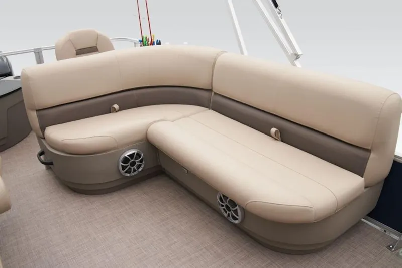 Slide: The Image of 2025 Sun Tracker BASS BUGGY® 18 DLX boat interior with beige seating and built-in speakers. - 4
