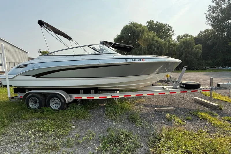 The Image of 2007 Formula 240 BR boat on trailer, parked outdoors with trees in the background. - 0