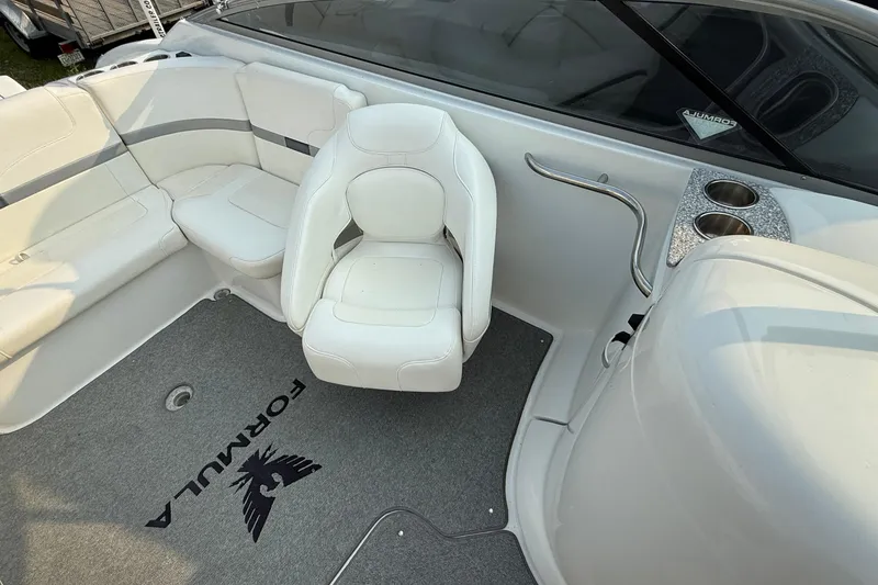 Slide: The Image of 2007 Formula 240 BR boat interior with white seating and carpeted floor. - 3