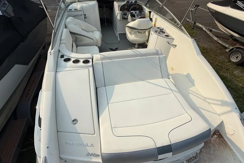 Slide: The Image of 2007 Formula 240 BR boat interior with white seating and steering console. - 4