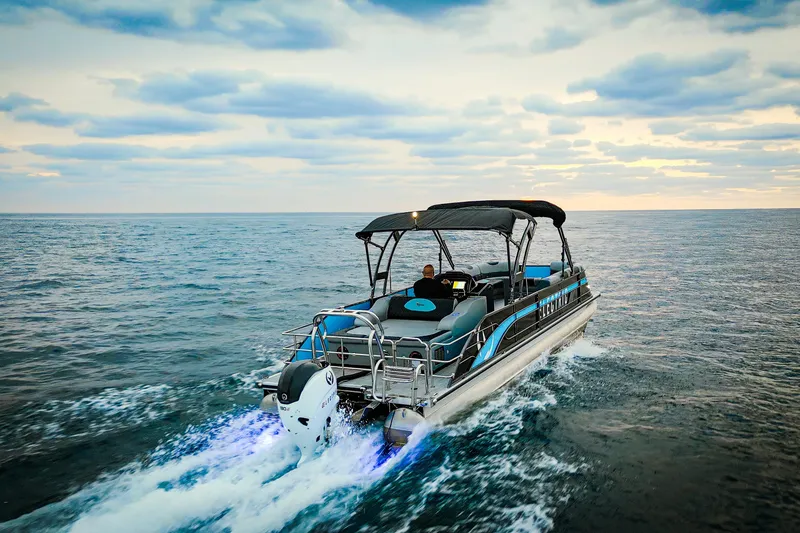 Slide: The Image of 2025 Vision Marine Technologies V30 boat cruising on open water at sunset. - 8