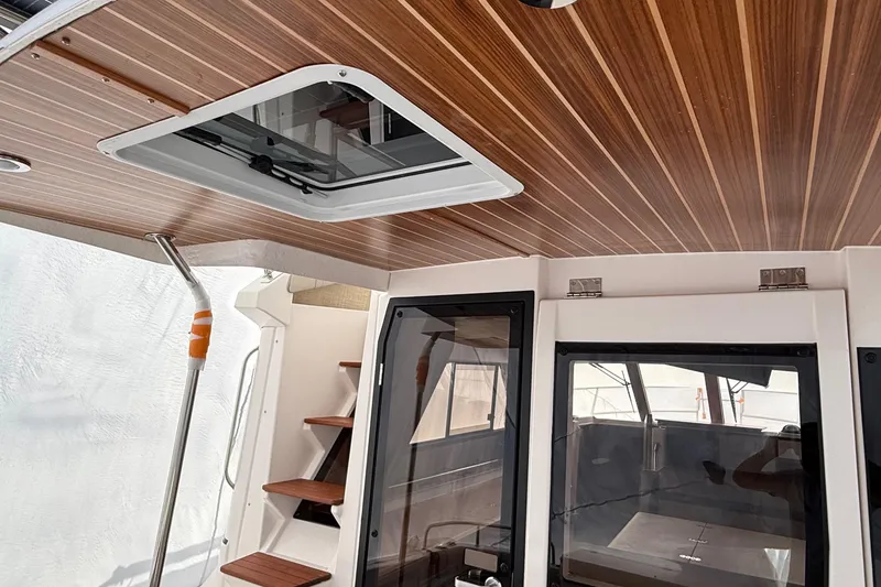 Slide: The Image of Interior of 2025 Cutwater C-32 CB boat with wooden ceiling and modern design. - 13