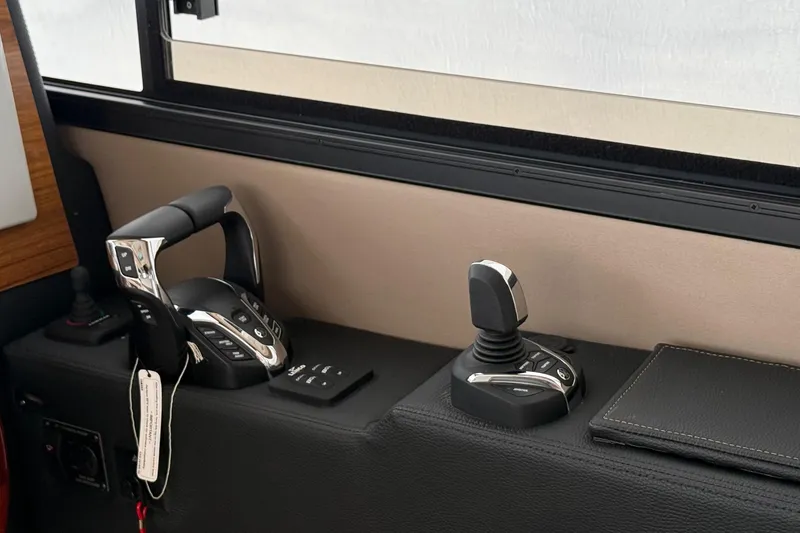 Slide: The Image of Control panel of 2025 Cutwater C-32 CB boat with joystick and throttle. - 17