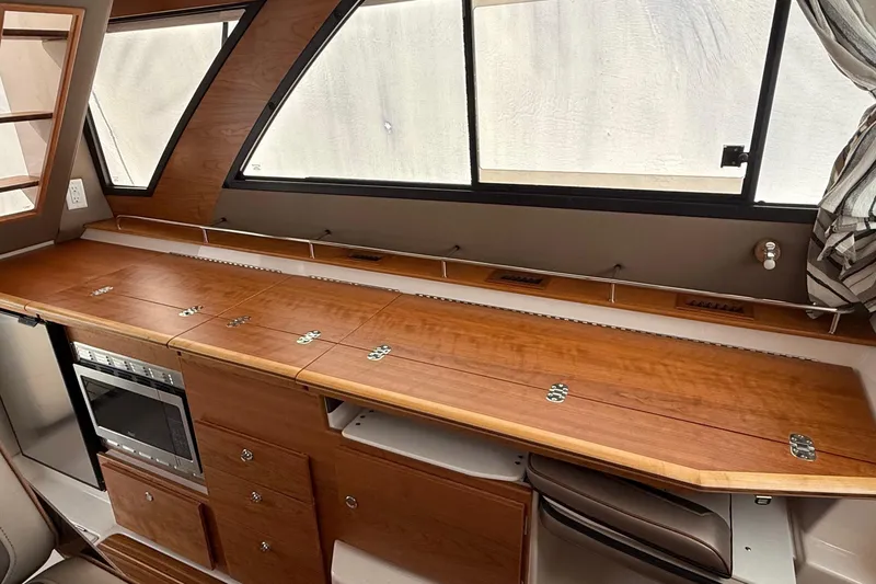 Slide: The Image of 2025 Cutwater C-32 CB interior with wooden cabinetry and modern appliances. - 22