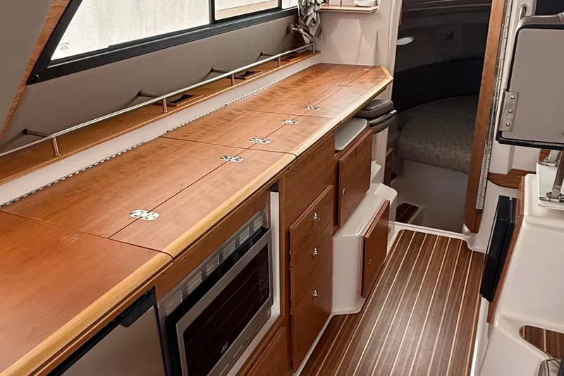 Slide: The Image of Interior of 2025 Cutwater C-32 CB boat with wooden cabinetry and modern amenities. - 24