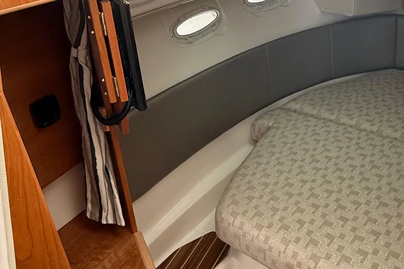Slide: The Image of 2025 Cutwater C-32 CB cabin interior with bed and portholes. - 28