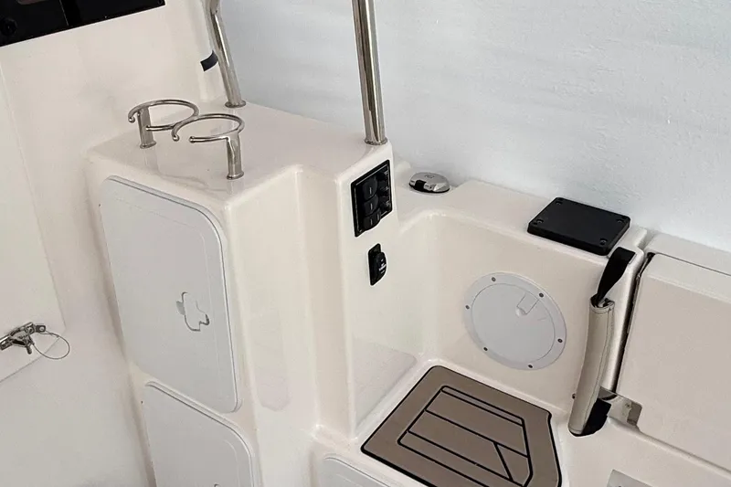 Slide: The Image of 2025 Cutwater C-32 CB boat interior with cup holders and storage compartments. - 7