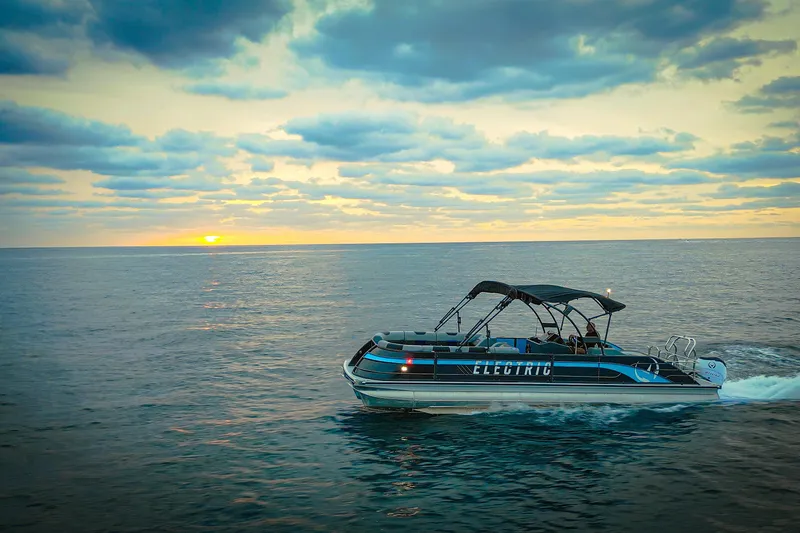 Slide: The Image of Electric Vision Marine Technologies V30 boat cruising at sunset, 2025 model. - 5