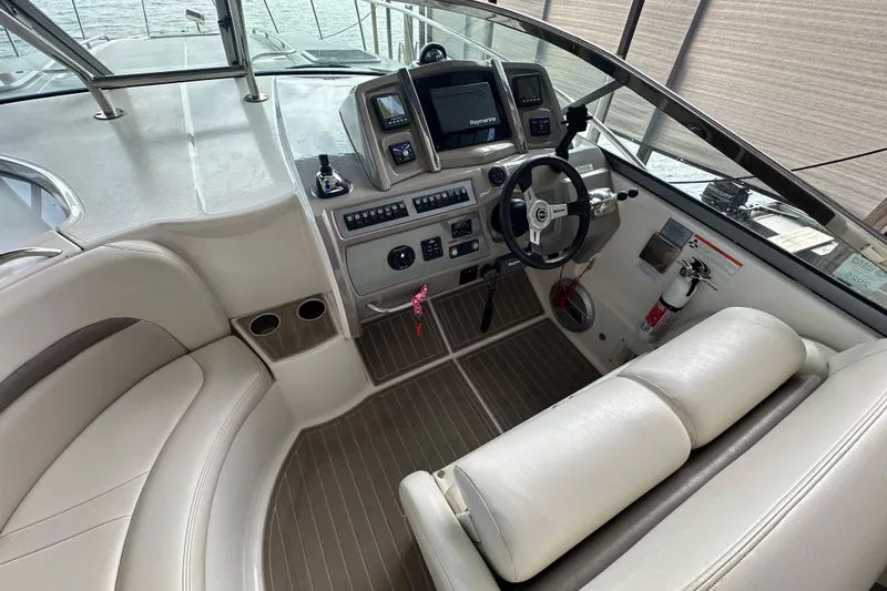 Slide: The Image of 2010 Chaparral Signature 370 boat cockpit with steering wheel and navigation controls. - 18