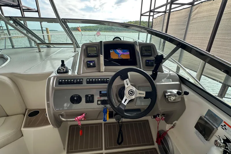 Slide: The Image of Cockpit of 2010 Chaparral Signature 370 boat with steering wheel and navigation controls. - 19
