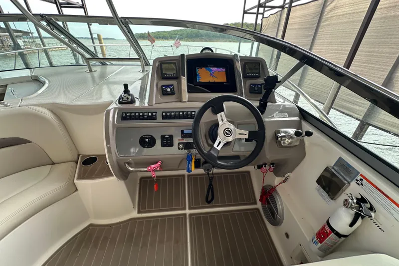 Slide: The Image of Cockpit of 2010 Chaparral Signature 370 boat with steering wheel and navigation system. - 20