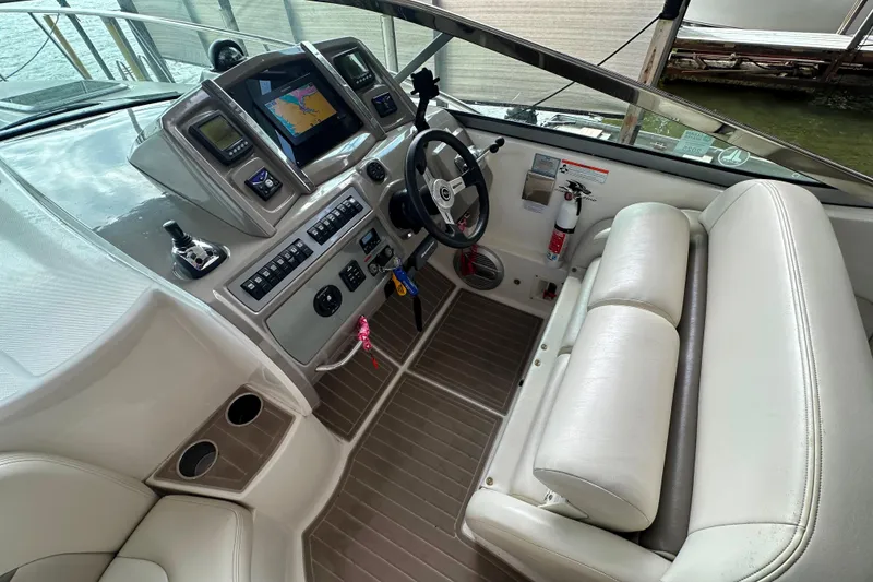Slide: The Image of 2010 Chaparral Signature 370 boat cockpit with steering wheel, navigation system, and seating. - 21