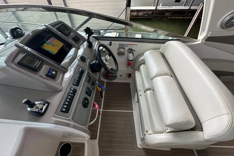 Slide: The Image of Cockpit of 2010 Chaparral Signature 370 with navigation system and white seating. - 22