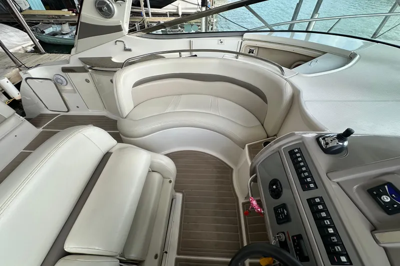 Slide: The Image of 2010 Chaparral Signature 370 boat interior with plush seating and control panel. - 25