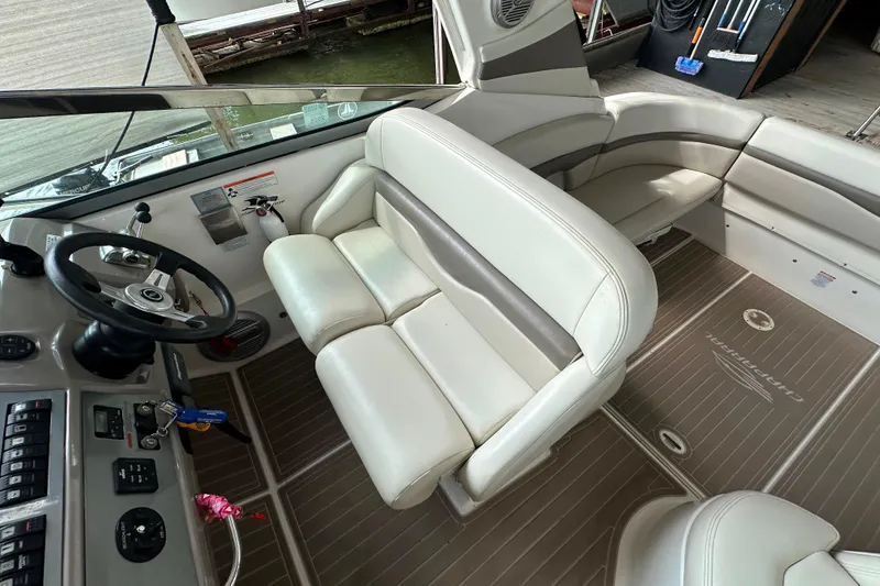 Slide: The Image of 2010 Chaparral Signature 370 boat interior with steering wheel and white seating. - 27