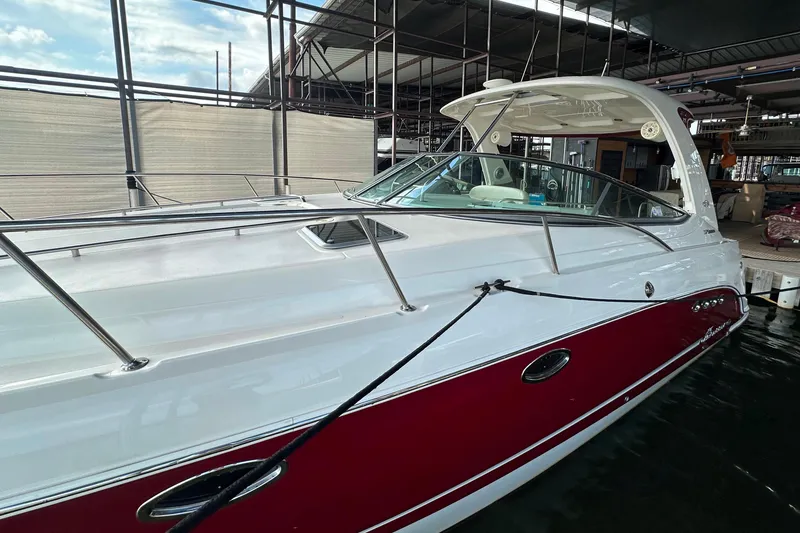 Slide: The Image of Chaparral Signature 370 boat, 2010 model, docked in a marina with red and white exterior. - 3