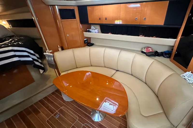 Slide: The Image of Interior of 2010 Chaparral Signature 370 yacht with leather seating and wooden table. - 32