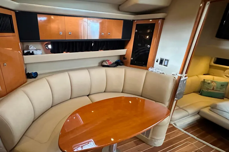 Slide: The Image of Interior of 2010 Chaparral Signature 370 yacht with elegant seating and wooden table. - 33