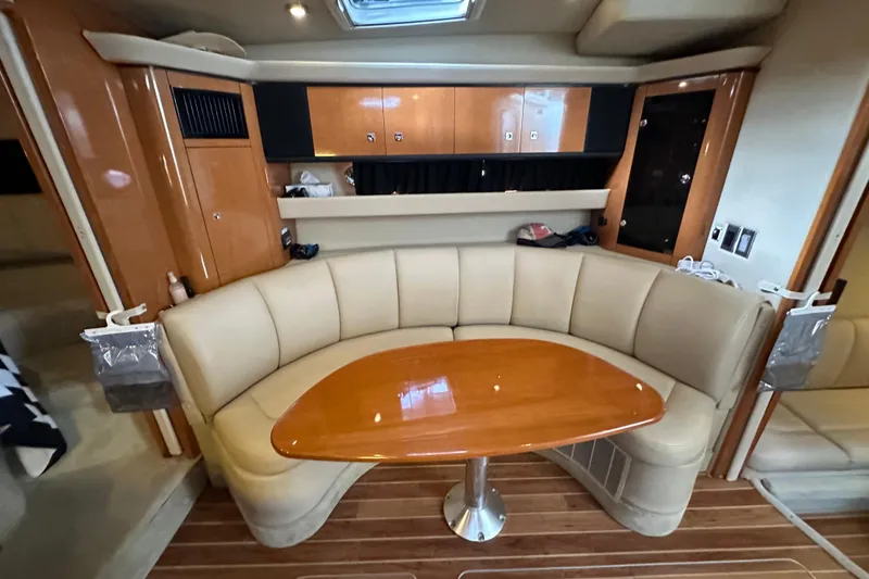 Slide: The Image of 2010 Chaparral Signature 370 interior with curved seating and wooden table. - 38