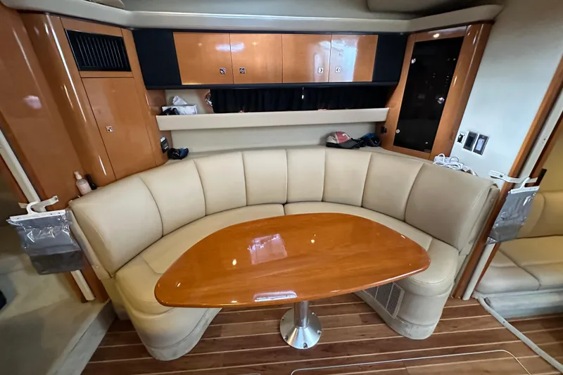 Slide: The Image of 2010 Chaparral Signature 370 interior with curved seating and wooden table. - 39