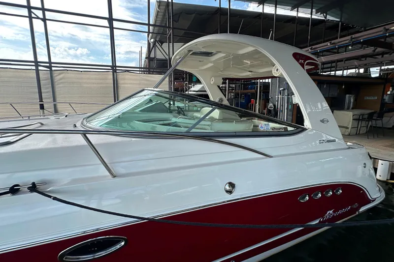Slide: The Image of 2010 Chaparral Signature 370 boat docked, featuring sleek design and red accents. - 4