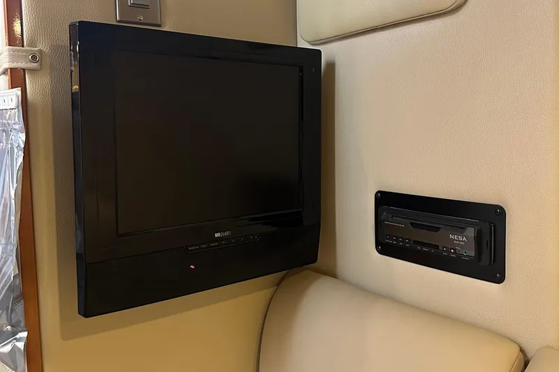 Slide: The Image of Flat-screen TV and audio system inside 2010 Chaparral Signature 370 boat cabin. - 48