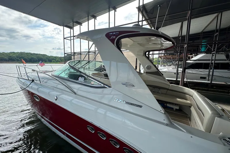 Slide: The Image of 2010 Chaparral Signature 370 boat docked, featuring sleek design and spacious seating. - 5