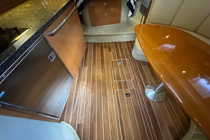 Slide: The Image of 2010 Chaparral Signature 370 interior with wood flooring, sleek table, and modern kitchen amenities. - 50