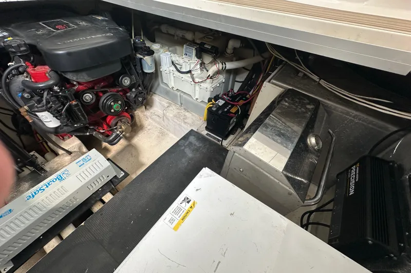 Slide: The Image of Engine room of 2010 Chaparral Signature 370 boat, showcasing mechanical components and wiring. - 56