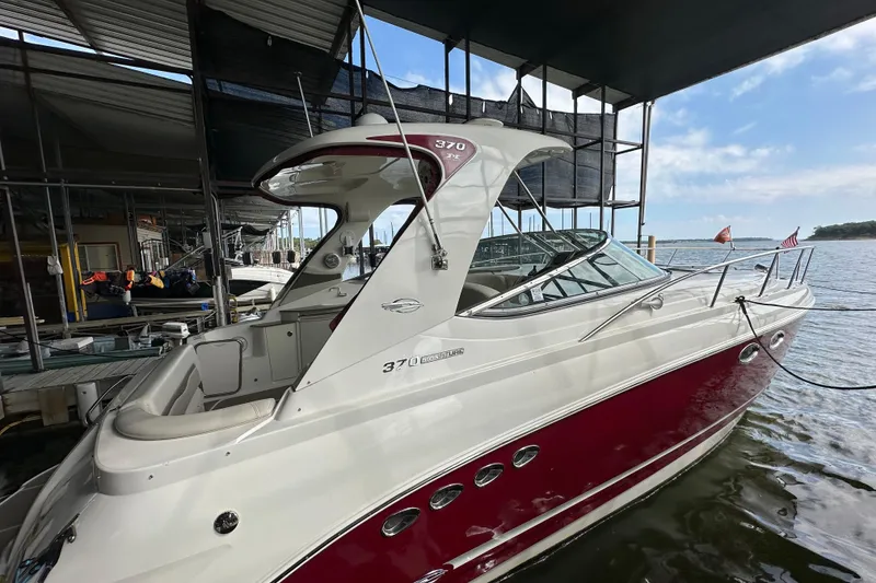 Slide: The Image of 2010 Chaparral Signature 370 boat docked, featuring sleek design and maroon accents. - 8