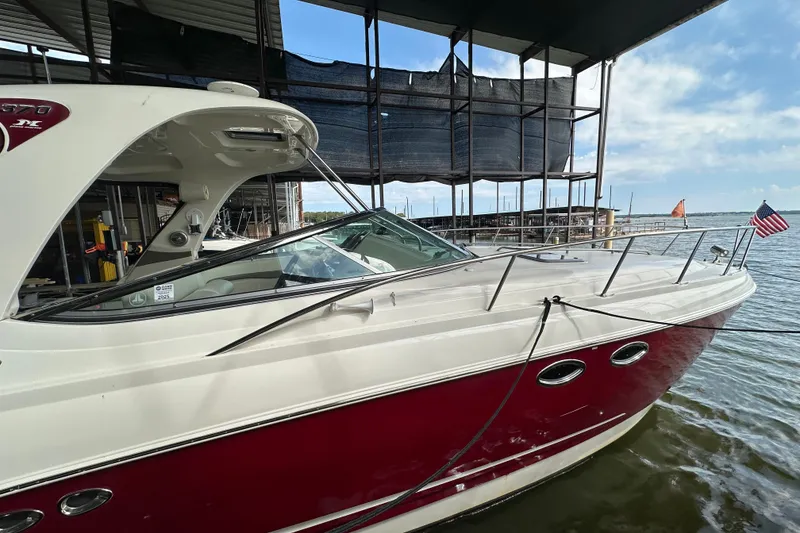 Slide: The Image of 2010 Chaparral Signature 370 boat docked, featuring sleek design and American flag. - 9