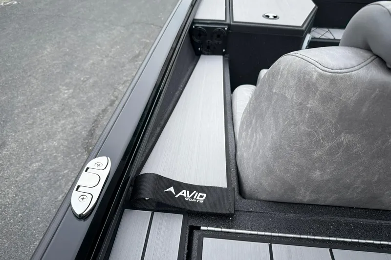 Slide: The Image of 2025 Avid 18 Vertex boat interior with gray seating and sleek design. - 13
