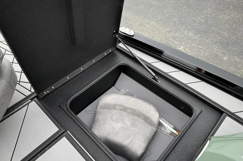 Slide: The Image of Open storage compartment in 2025 Avid 18 Vertex boat, featuring a seat and accessories. - 17