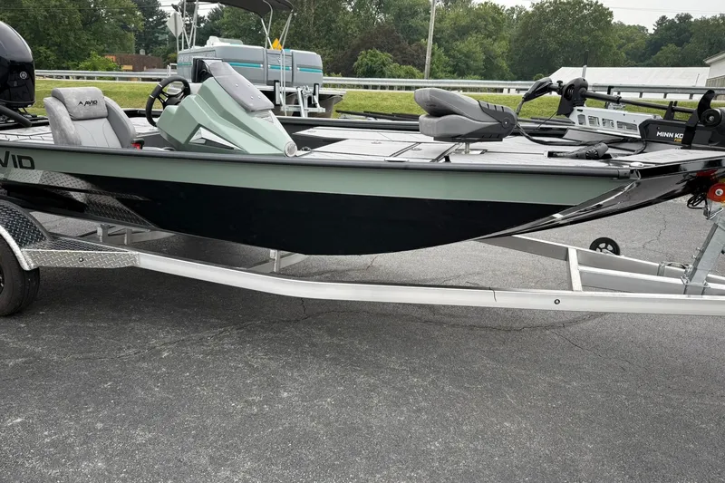 Slide: The Image of 2025 Avid 18 Vertex boat on trailer, parked outdoors, featuring sleek design and modern equipment. - 5