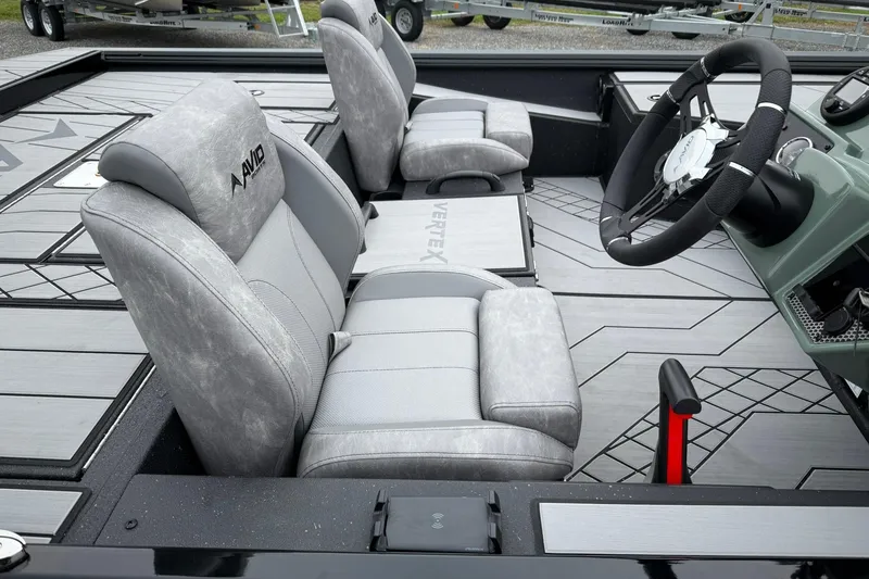 Slide: The Image of 2025 Avid 18 Vertex boat interior with gray seats and modern steering wheel. - 7