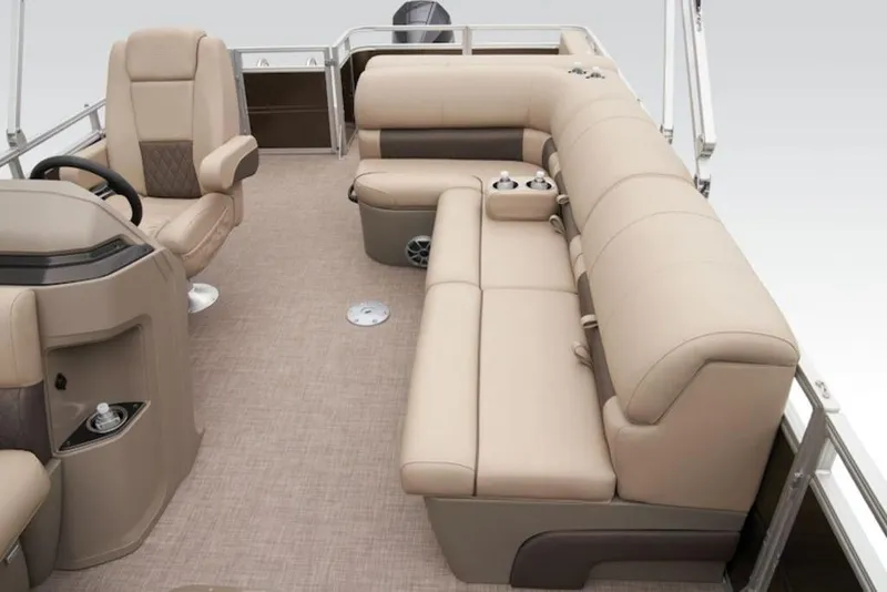 Slide: The Image of 2025 Sun Tracker Sportfish™ 24 XP3 interior with beige seating and steering console. - 12