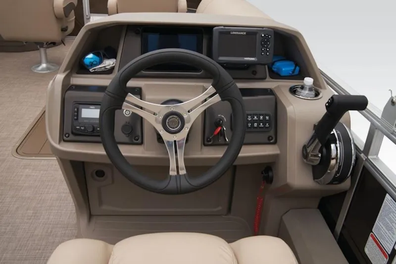Slide: The Image of 2025 Sun Tracker Sportfish™ 24 XP3 helm with steering wheel and control panel. - 9
