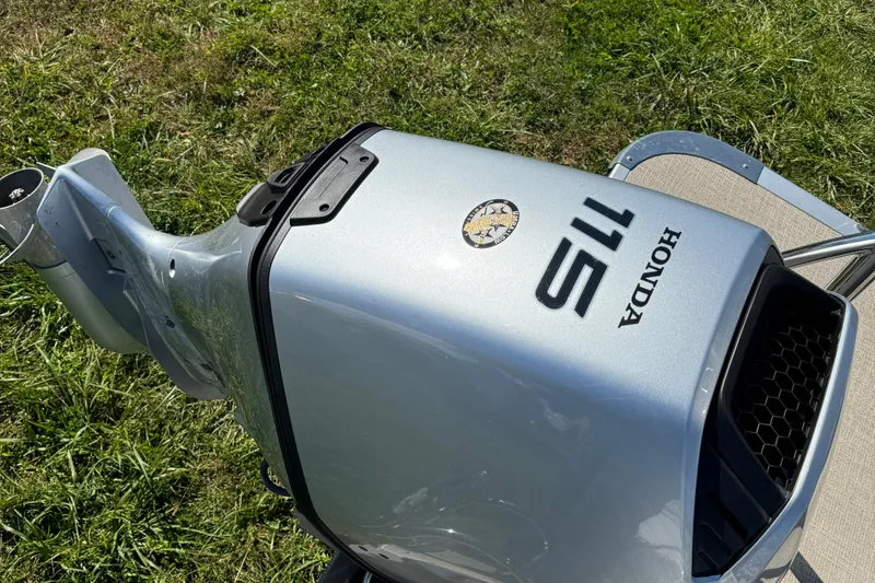 Slide: The Image of Honda 115 outboard motor on 2022 Avalon LSZ Quad Lounger 2385, grass background. - 4