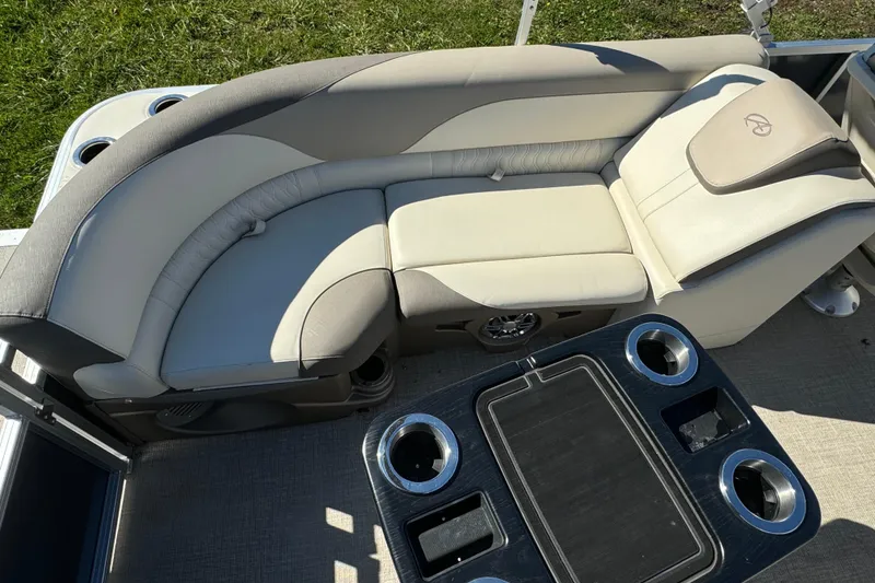 Slide: The Image of Luxurious seating on 2022 Avalon LSZ Quad Lounger 2385 pontoon boat with cup holders and table. - 6
