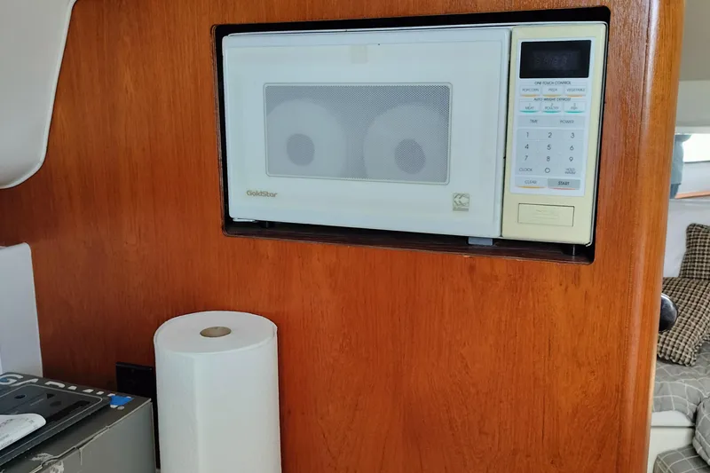 Slide: The Image of Microwave in 1995 Tiara Yachts 2900 Open interior with wooden paneling. - 10